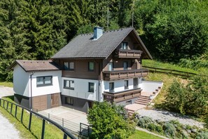 A two-story house with a balcony, surrounded by greenery. - Alpenpanorama Assach 2 (Aich-Assach)