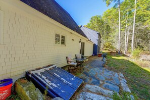 A house with a stone patio, a blue door, and a small outdoor seating area. - Spacious Home w/ Fire Pit, 8 Mi to Dtwn Portland (Falmouth)