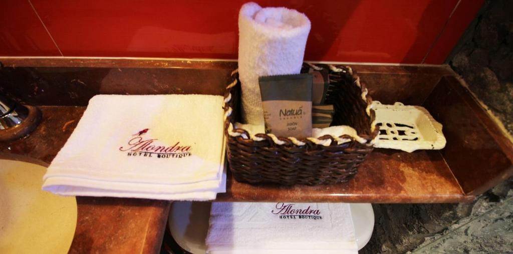 A bathroom counter with a towel, a basket containing toiletries, and a soap dish.