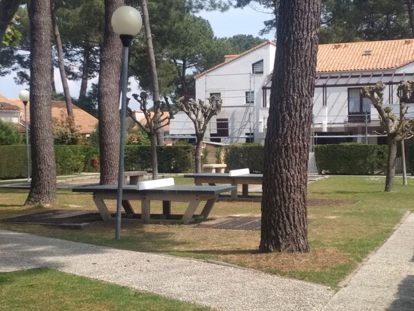 A park with picnic tables and a lamp post. - New Listing (Les Mathes)