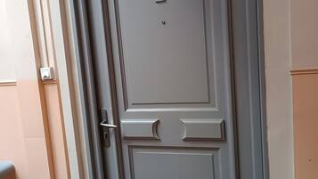 A door with the number 2, a handle, and a small square object above it.