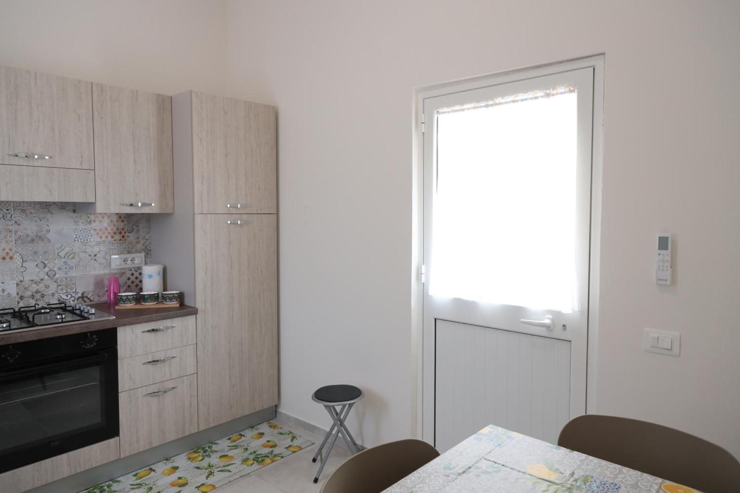 A compact kitchen with a gas stove, oven, and a small dining area with a table and chairs.