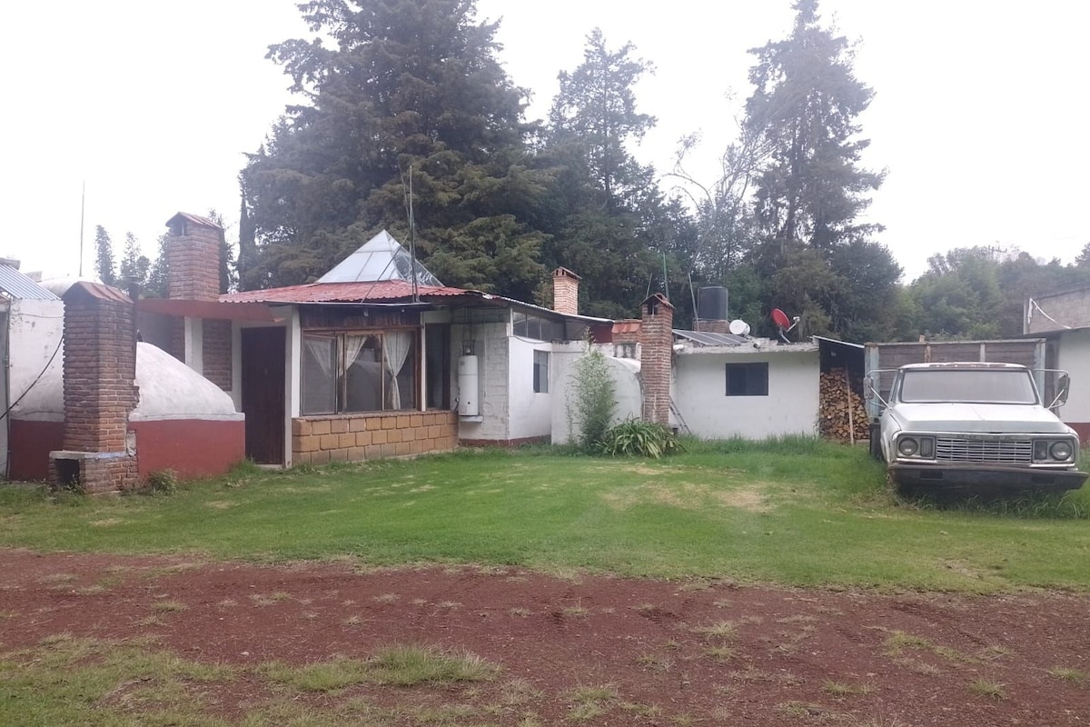 A residential property with a single-story house, a garage, and a parked car.