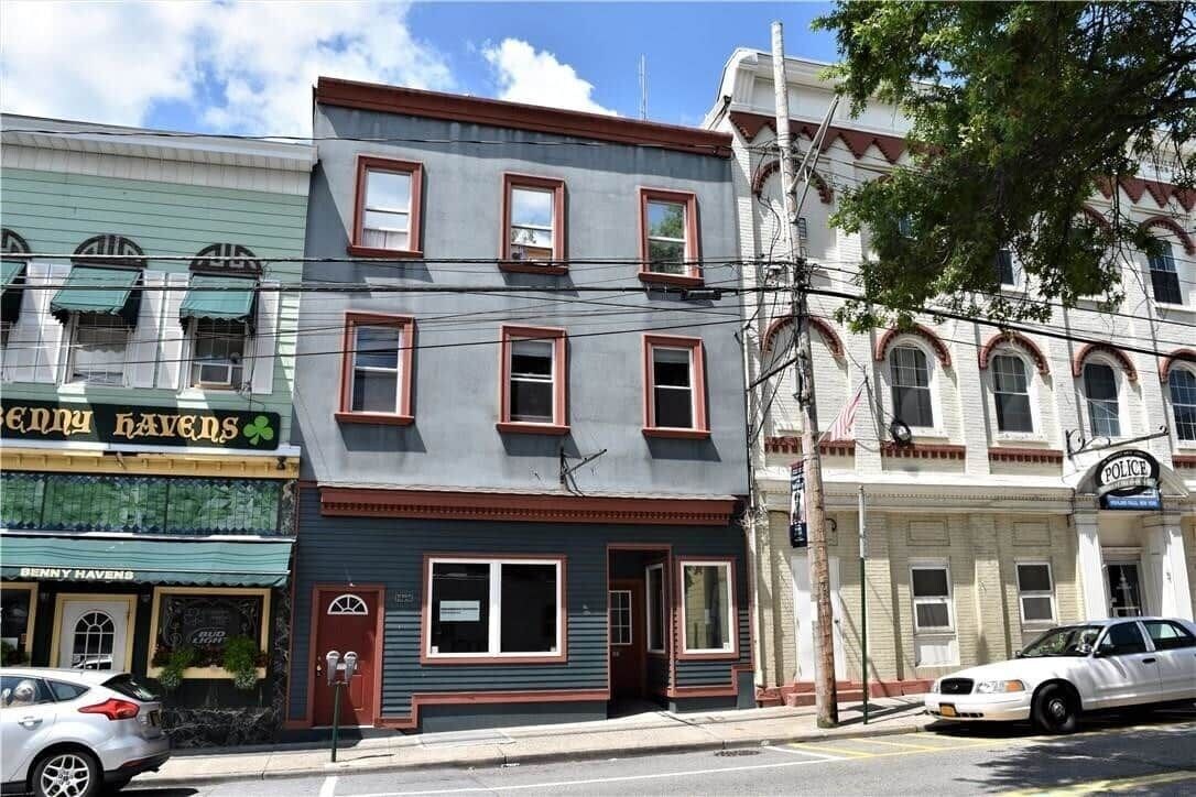 A multi-story building with a storefront labeled 'Benny Havens.'