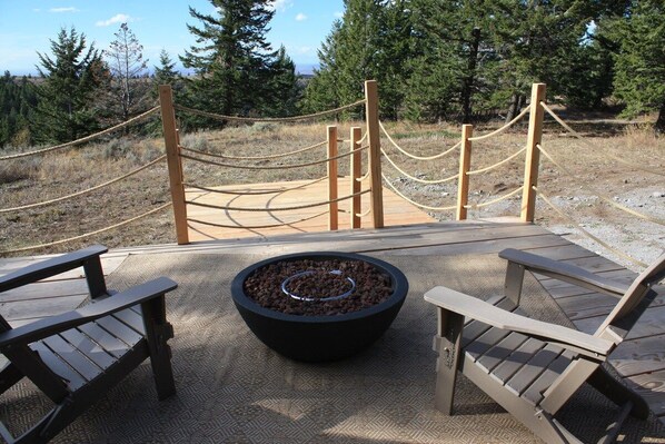 A wooden deck with a fire pit and Adirondack chairs. - Sunset Ridge - Kelly Canyon Dome (Ririe)