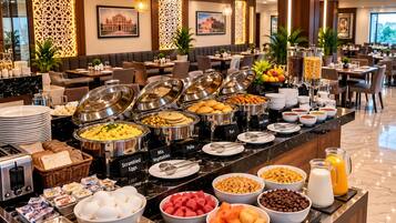 A buffet with various food options including scrambled eggs, poha, and mixed vegetables.