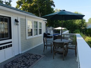 A patio with a pool table, outdoor seating, and a covered area with an umbrella. - Cozy 3-Bedroom, 2-Bath Home with Private Pool & Hot Tub, Chester Front Harbour (Chester)
