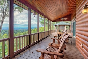 A wooden deck with a view of a forested landscape. - Luxury Blue Ridge Retreat, Panoramic Layered Mountain Views & Hot Tub (Morganton)