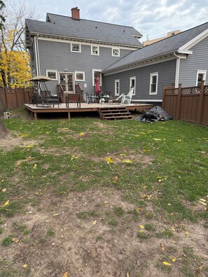 A residential backyard with a deck, outdoor furniture, and a fenced area. - Spacious 4-bedroom house in Brighton-Rochester close to everything-dog friendly (Brighton)