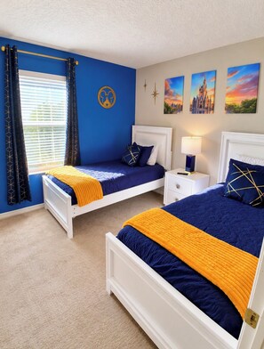 A bedroom with two beds, a window with curtains, a nightstand, a lamp, and wall art. - 4BR/3BA Disney Retreat Pool & Lazy River/Patio/ lFitness rm Near all attractions (Davenport)