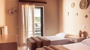 A bedroom with two beds, a window with curtains, a bedside table with a lamp, and wall decor. - 3BR | Sea View | Entire Place | 100m from Beach | Olive Grove (Kipseli Drosia)
