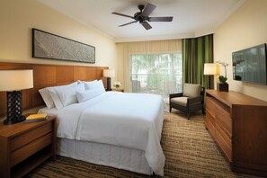 A hotel room with a large bed, a wooden headboard, a ceiling fan, a TV, a chair, a dresser, and a window with curtains. - Westin Ka'anapali Ocean Resort Villas, 1 Bdrm Premium Oceanview Villa (Lahaina)