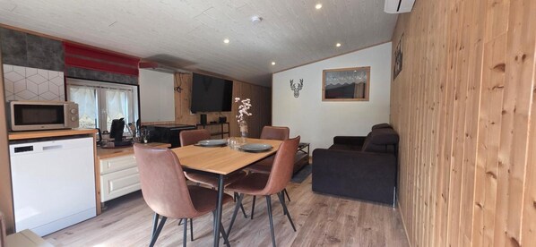 A compact living space with a kitchen, dining area, and seating.