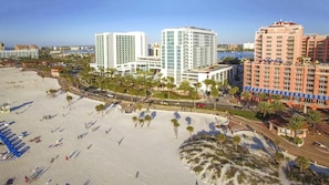 A beachside hotel with multiple buildings, a sandy beach, and palm trees. - Soak Up the Sunshine at Wyndham Clearwater Beach-1 Bedroom Deluxe (Clearwater)