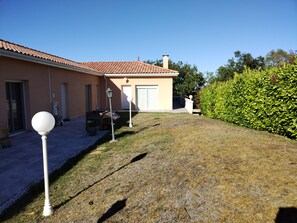 A residential property with a paved driveway, a lawn, and a well-maintained hedge. - New Listing (Auch)