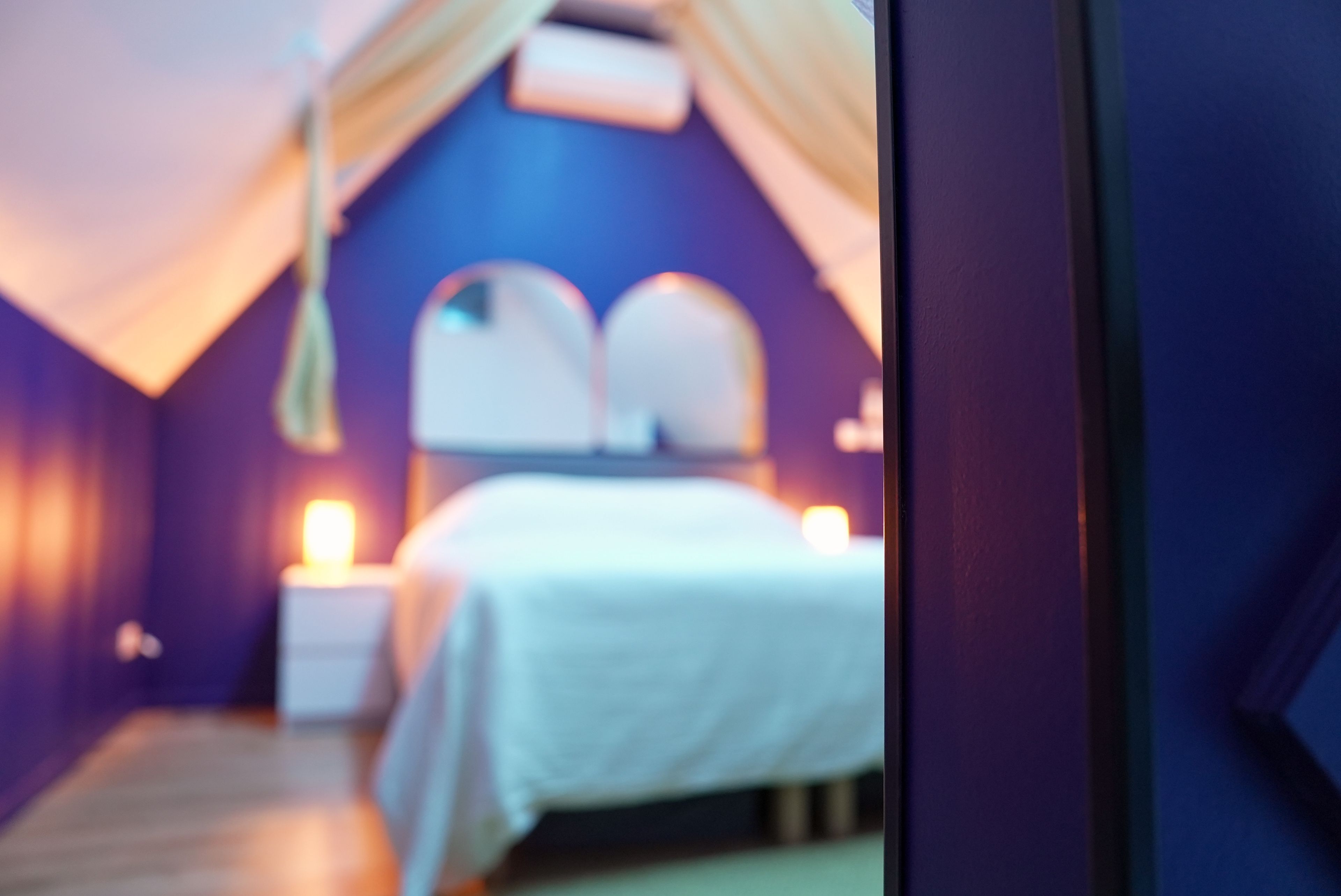 Ein Schlafzimmer mit einem Bett, Nachttischen und einem Baldachin.