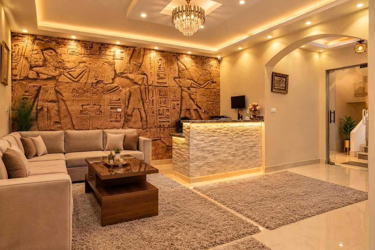A modern living room with a stone wall, a sofa, a coffee table, and a reception desk.