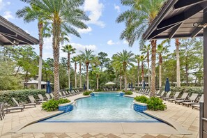A pool area with lounge chairs and palm trees. - 🏖️ Caspian Blue | Beach Access, Pool, Bikes & Screened Porches 🚲 (Inlet Beach)