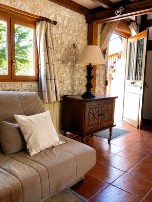 A cozy room with a sofa, a lamp, and a wooden cabinet. - New Listing (Léry)