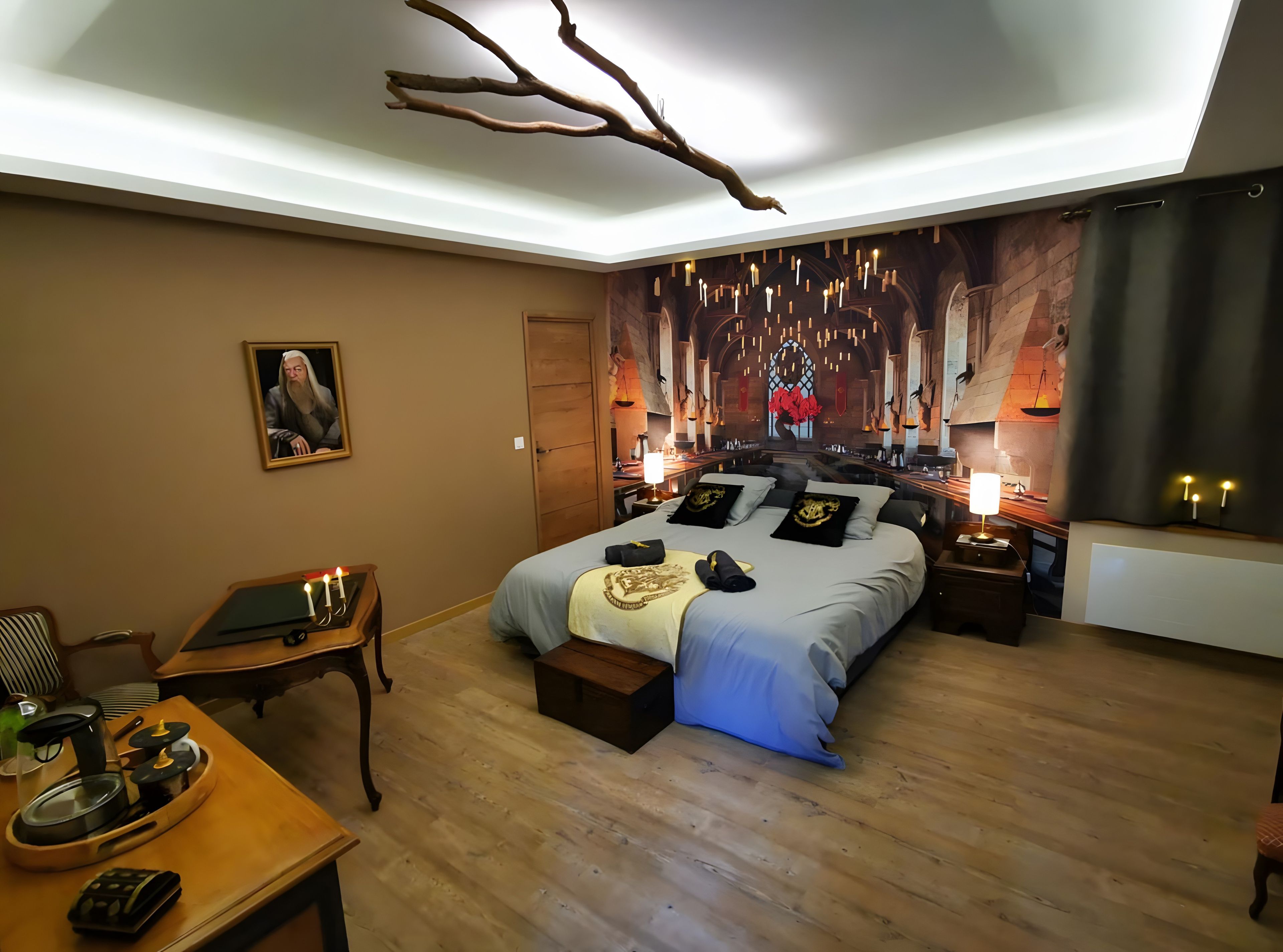 A hotel room with a large bed, bedside tables, a desk, and a painting on the wall.