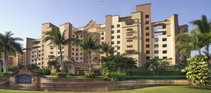 A multi-story hotel with a central courtyard, palm trees, and a stone fountain. - 2 bedroom Suite at a AAA rated 4 diamond exclusive resort over Christmas! (Nuevo Nayarit)
