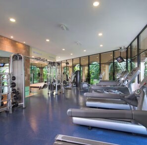 A gym with treadmills, weight machines, and a mirrored wall. - 2 bedroom Suite at a AAA rated 4 diamond exclusive resort over Christmas! (Nuevo Nayarit)