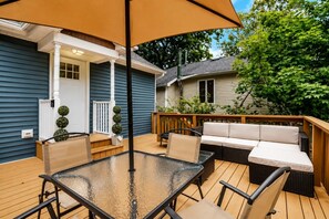 Private Furnished Deck — Enjoy outdoor dining and lounging on the private deck surrounded by peaceful greenery.