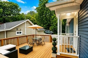 Outdoor Deck Seating — Furnished private deck offering a comfortable place for morning coffee, meals, or evening relaxation.