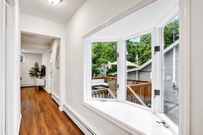 right Hallway & Deck Access — Large windows bring in natural light while offering easy access to the private outdoor deck.