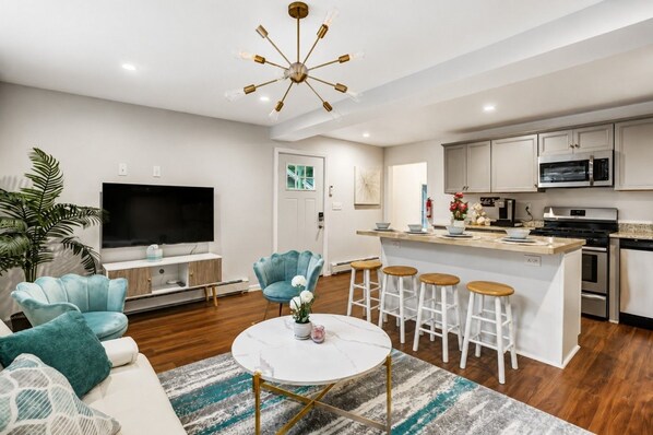 A modern living room with a TV, sofa, and a coffee table.