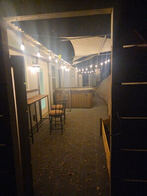 A dimly lit room with a bar area, a chair, and a table. - Charming 3-bedroom house with AC in lovely Three Rivers (Three Rivers)