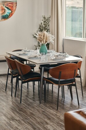 A dining area with a round table set for four, surrounded by chairs with leather seats and metal legs. - The Red Canyon Retreat - Views, Hot Tub, Game Room (Page)