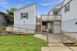 A residential property with a covered outdoor area, a wooden deck, and a stone pathway. - Riverlight - Nehalem Riverfront for 2 (Nehalem)