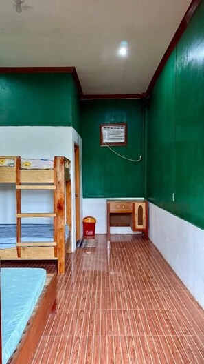 A room with bunk beds, a desk, and a small cabinet. - Felban's Farm (Carmen, Bohol)