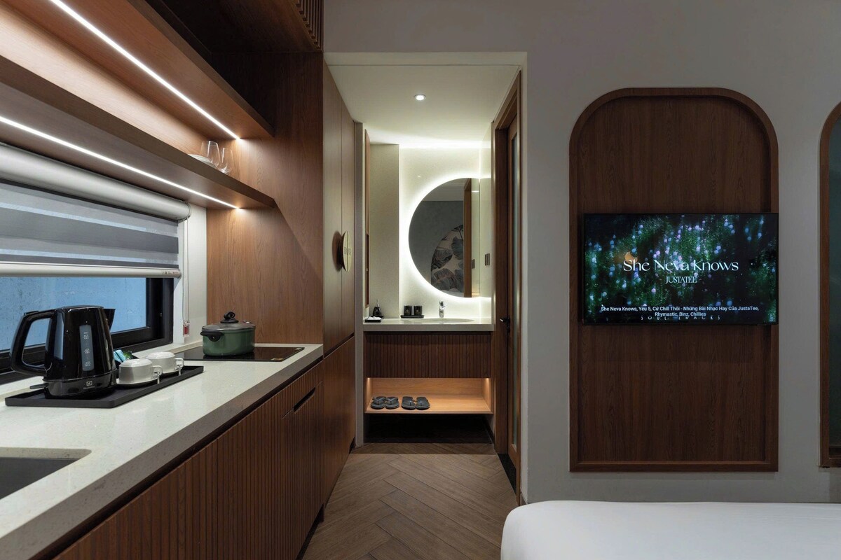 A modern kitchen with a coffee maker, a kettle, and a microwave.