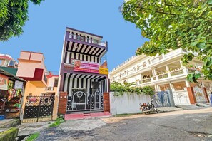 A multi-story building with a sign for Ganpati Home Stay, featuring a black gate with decorative elements. - Hotel O Prem Nagar Dehradun (Dehradun)