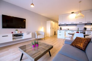 Eine moderne Wohnung mit Wohnzimmer, Küche und Essbereich.