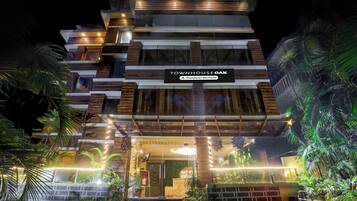 A multi-story building with a sign indicating it is a company-serviced townhouse.