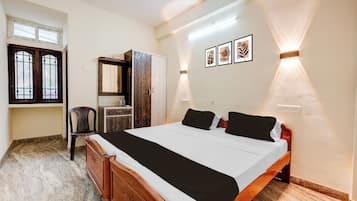 Ein Schlafzimmer mit Bett, Schrank, Schreibtisch und Stuhl.