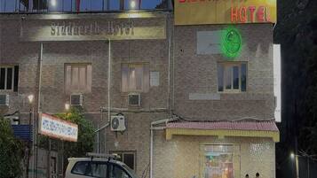 A building with a sign for Siddharth Hotel and a Family Restaurant.