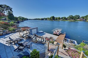 Un muelle con un bote, asientos al aire libre y vistas al río.