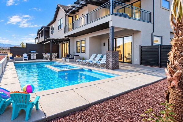 A modern two-story house with a swimming pool, outdoor seating, and a view of the mountains. - Aloha Poolhouse #52: Private Pool (Santa Clara)