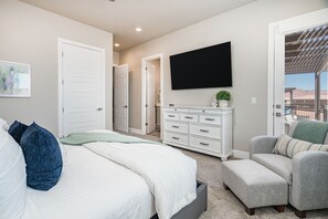 A bedroom with a bed, a dresser, a TV, and a chair. - Aloha Poolhouse #52: Private Pool (Santa Clara)