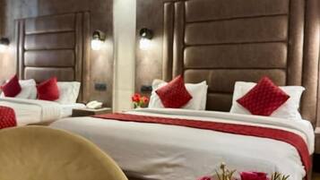 A hotel room with a large bed, a bedside table, and a chair.
