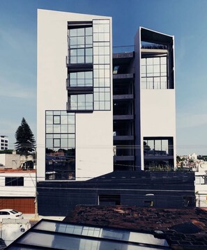 A modern multi-story building with large windows and balconies. - Apartment with Beautiful Views | 202 (Puebla)