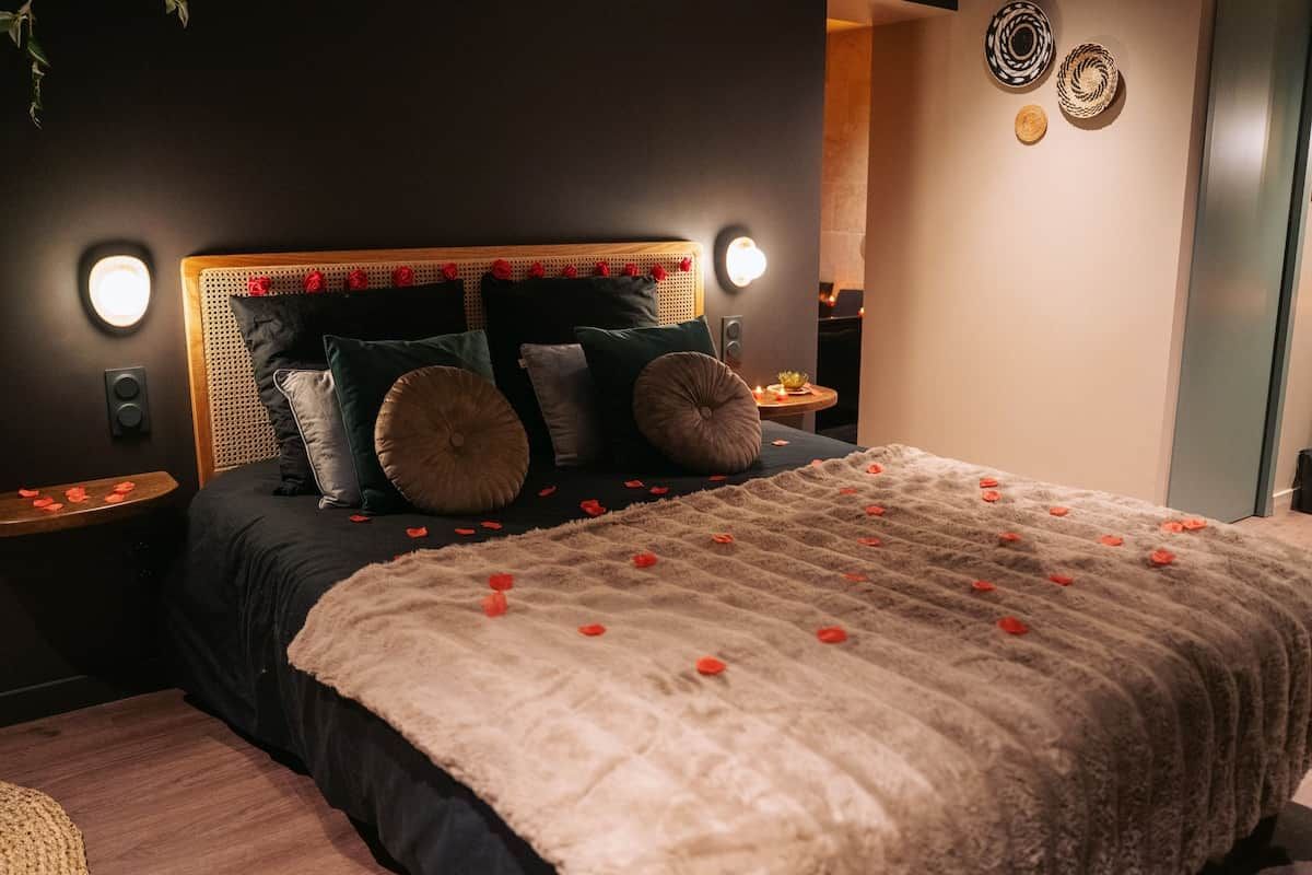 A bedroom with a bed, bedside tables, and decorative wall art.