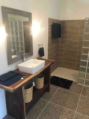 A bathroom with a white sink, a mirror, a towel rack, and a shower area. - Private Room Steps to Beach Tropical Garden Retreat Breakfast Included (Punta Perula)