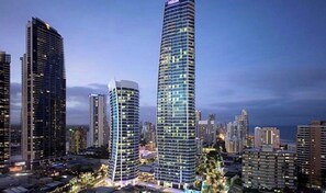Stadsbeeld met hoge gebouwen, waaronder een hotel met een opvallend golvend ontwerp.