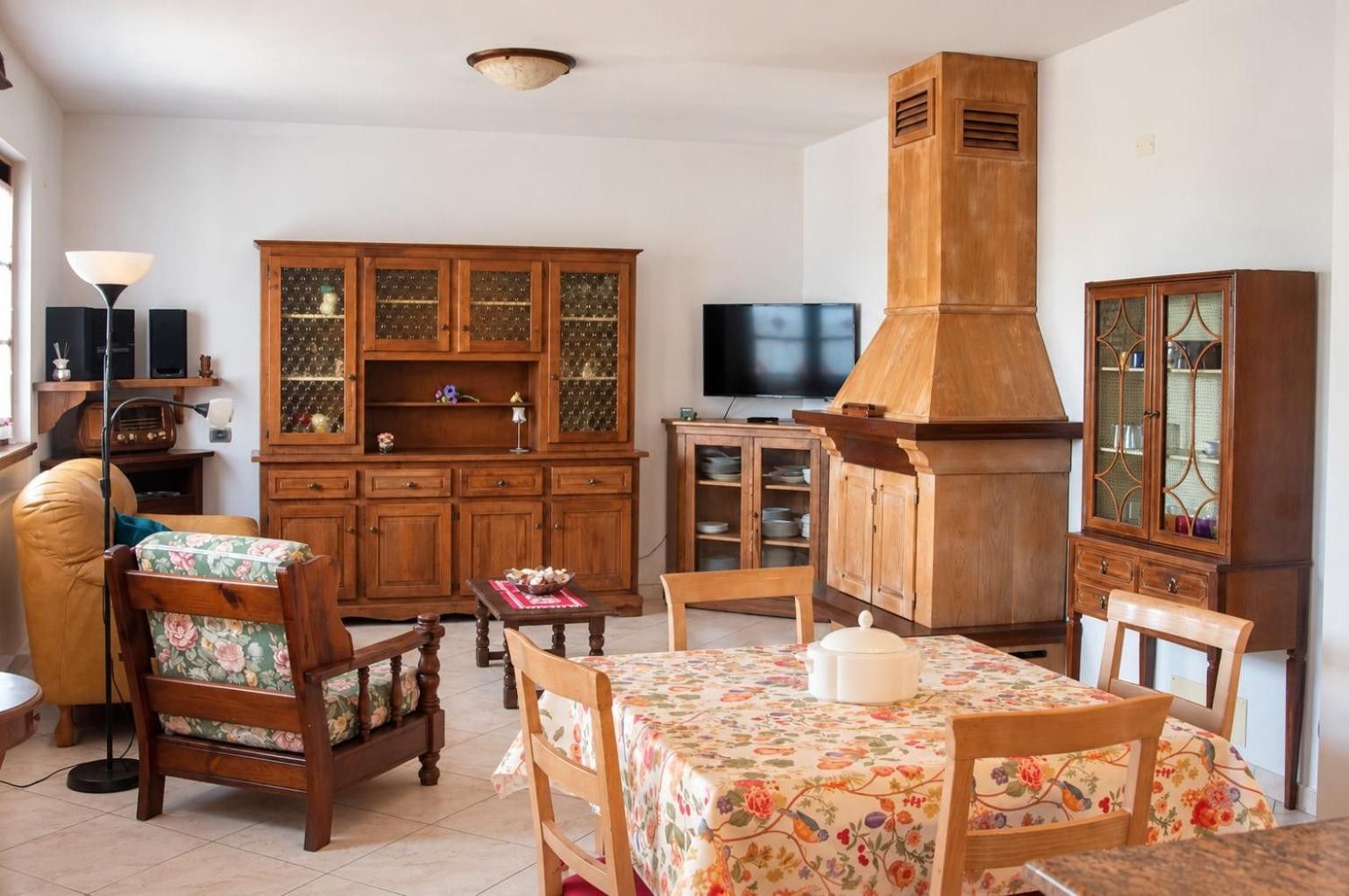 Un salon traditionnel avec des meubles en bois, un téléviseur et une cheminée.