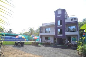 A multi-story building with a flat roof and a balcony on the upper floor. - Mamachi Wadi Resort (Alibaug)